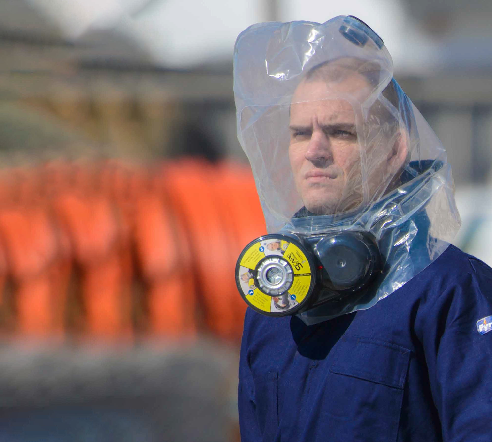 Product photo demonstrating an ILC Dover SCape escape respirator in use.